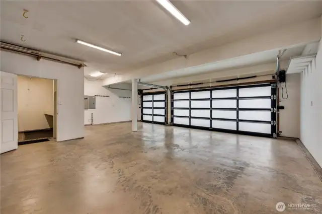 3 car garage with updated doors. The 3rd stall is about 15 feet, to make room for the laundry area to the left. This laundry backs to the den.  It seems possible to relocate the laundry to the den area, if desired.