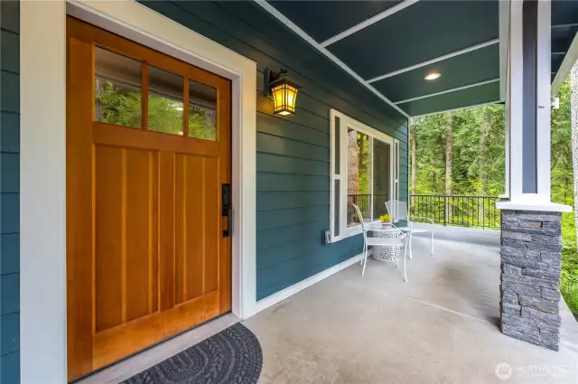 Covered front porch to enjoy the beautiful, natural setting.
