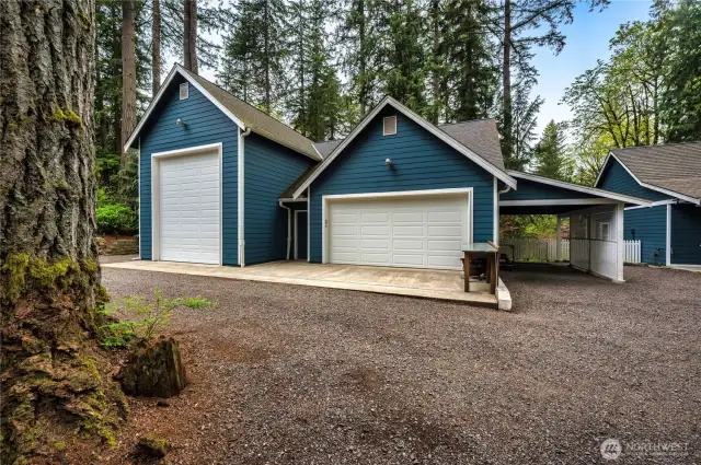 RV garage with 16'doors and 12' wide. Approx 39' deep. Two car garage/workshop on the right with storage above. Covered storage on each "wing" for extra vehicles or tractors.
