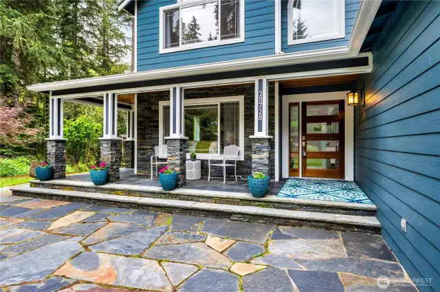 Gorgeous mahogany entry door welcomes you! This lovely flagstone patio wraps around 3 sides of the home.