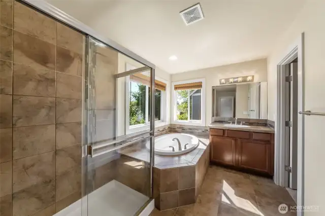 Soaking tub and glass enclosed shower.