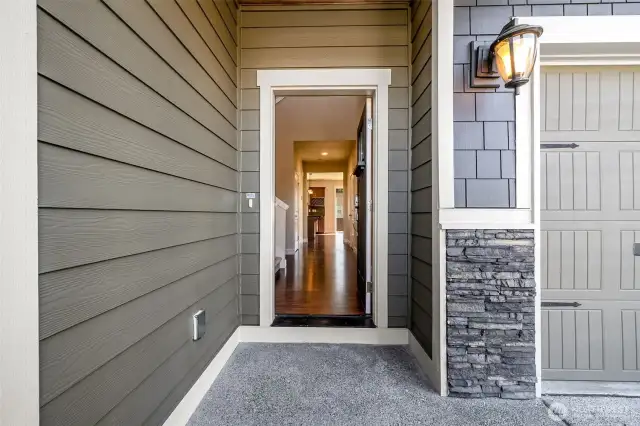 Enter under the covered front porch.