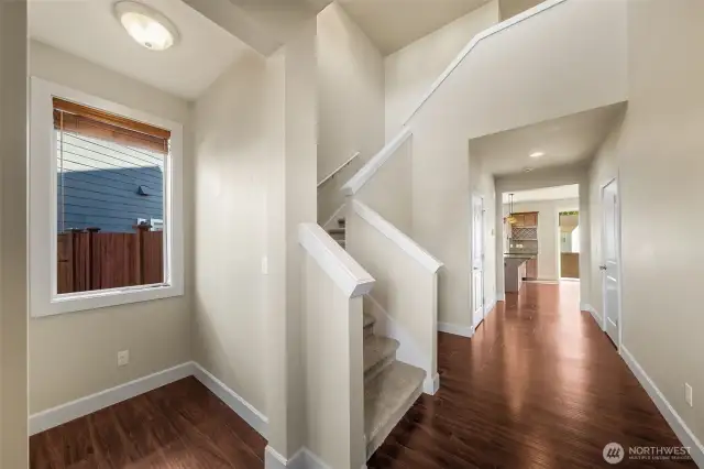 Enter to foyer. Take the stairs to the bedrooms or head down the hall to the kitchen and family room.