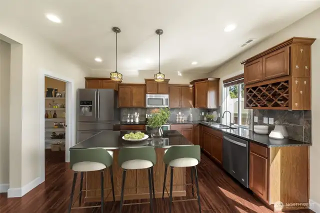 Kitchen w/ walk in pantry, bar area, motion sensor on the kitchen sink, wine rack and lots of cabinet space. (virtually staged)