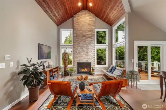 From the time you enter, prepare to be astounded by the dramatic updates which makes this home a piece of art. Wood-clad vaulted ceiling and towering stone fireplace create that northwest vibe.