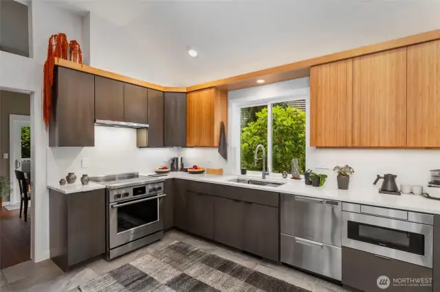 Miles of quartz counters and backsplash beautify the spacious kitchen.