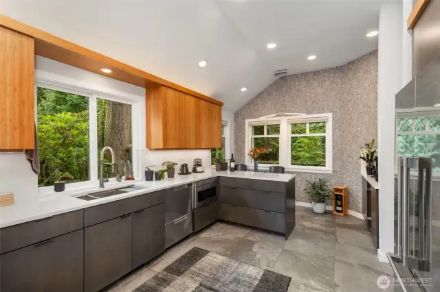 Designer stone tiles create a natural warmth in the kitchen, which has been recently updated with new paint and wallpaper.