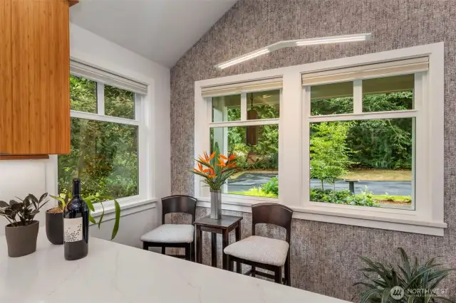 Cozy breakfast nook, surrounded by windows, creates a special space to gather.