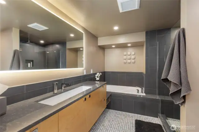 The luxurious primary ensuite has been recently updated with new tile surround throughout, designer fixtures and lighted mirror. Mosaic tile radiant heated floors provide the utmost comfort and add to the spa-like experience.