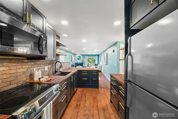 Single-bowl undermount sink with a sleek matte black finish and stainless steel appliances