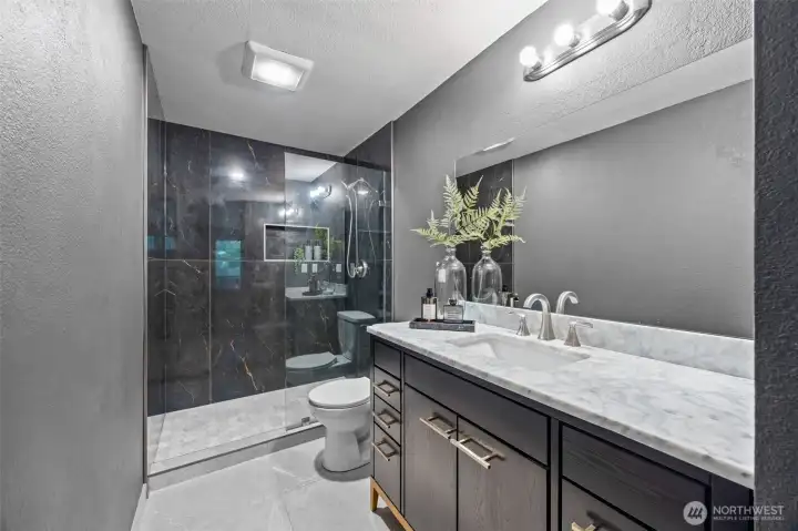 Sleek bathroom with large-scale tile walk-in shower