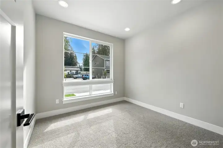 main floor bedroom or office  photo of  completed home on another lot.