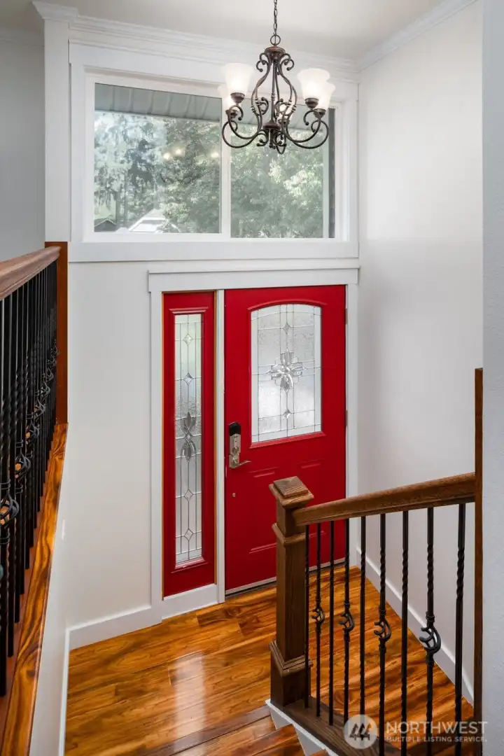 Light-filled entryway featuring engineered hardwood stairs.