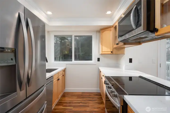 Kitchen has been recently painted and features new quartz countertops.