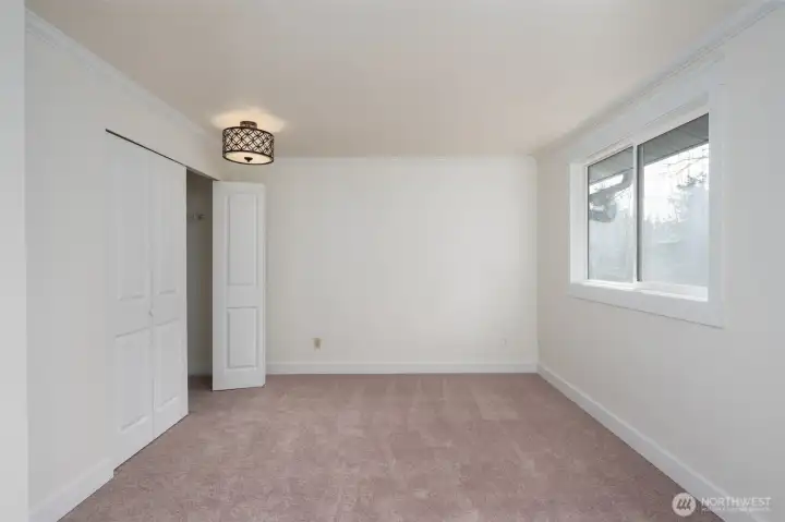 Primary bedroom features new paint, new carpet, and an updated en-suite bathroom.
