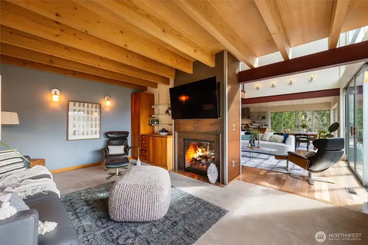 Tucked behind the great-room shared fireplace is this cozy family room boasting warm wood tones and lake views.