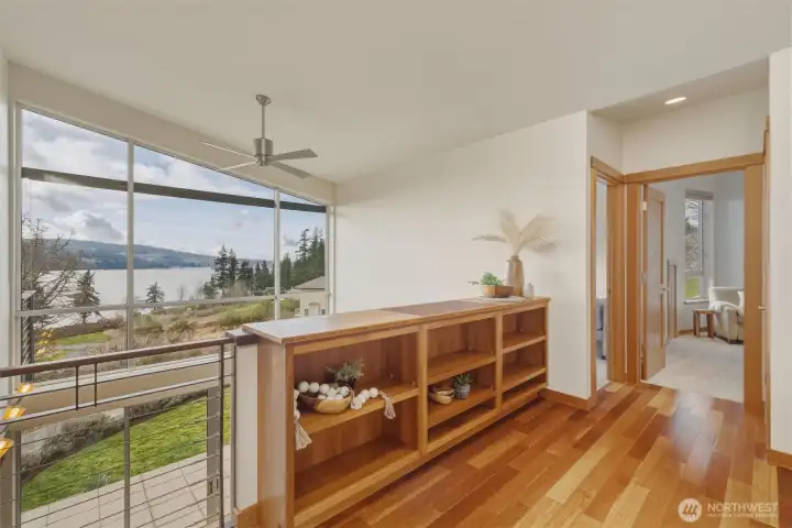 The loft, sitting above the living room enjoys tremendous views and boasts cherry wood cabinetry built-ins for beauty and functional use of the space.