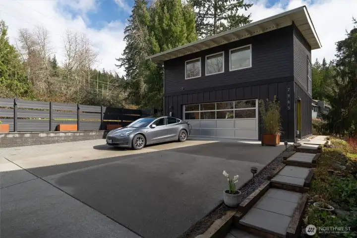 Enjoy the two car garage (26' x 26'), w/ car charging station. Above is a bonus space with 3/4 bath and kitchenette. And above on the roof... solar!