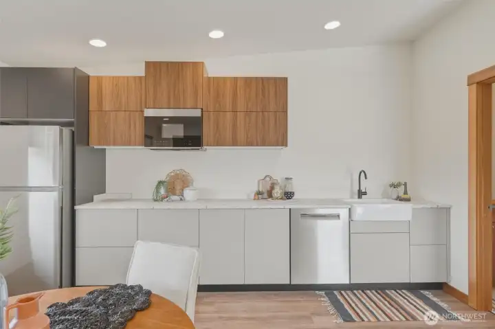 Kitchenette is equipped with included Bosch dishwasher, microwave, sink, and new refrigerator.