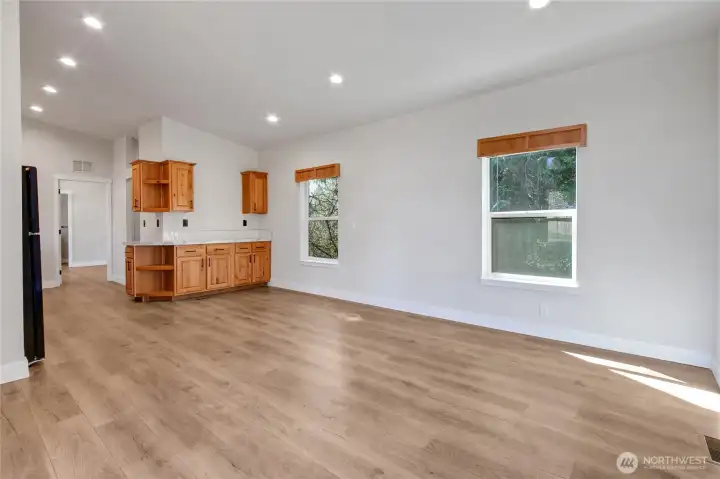 Step into the light filled dining area and kitchen that offers tons of cabinets for extra storage and counters.
