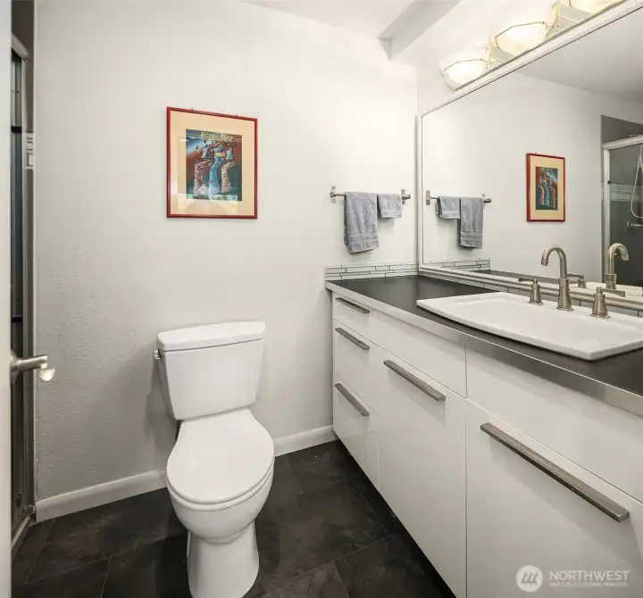 Second bath offers generous storage and a shower