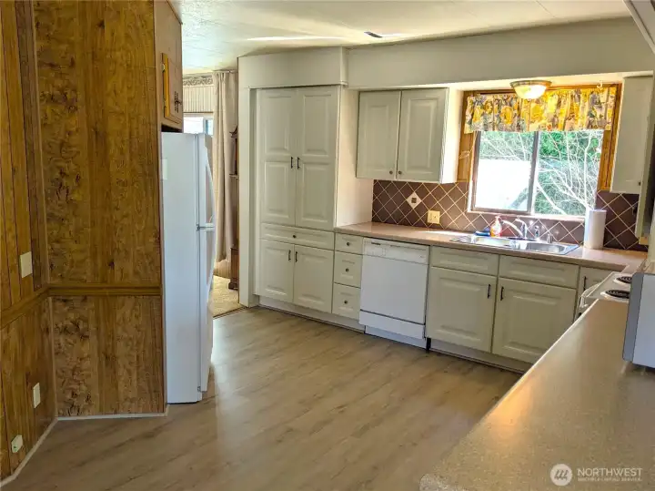 The light and bright Kitchen has a new vinyl floor and newer appliances