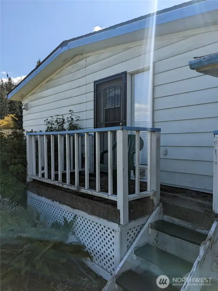 The back porch and door to the Primary Bedroom
