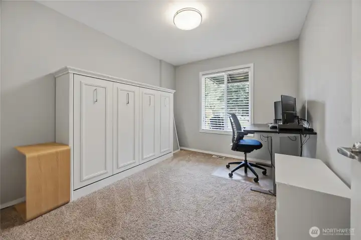 Flexible office space featuring a built-in Murphy bed that stays with the home.