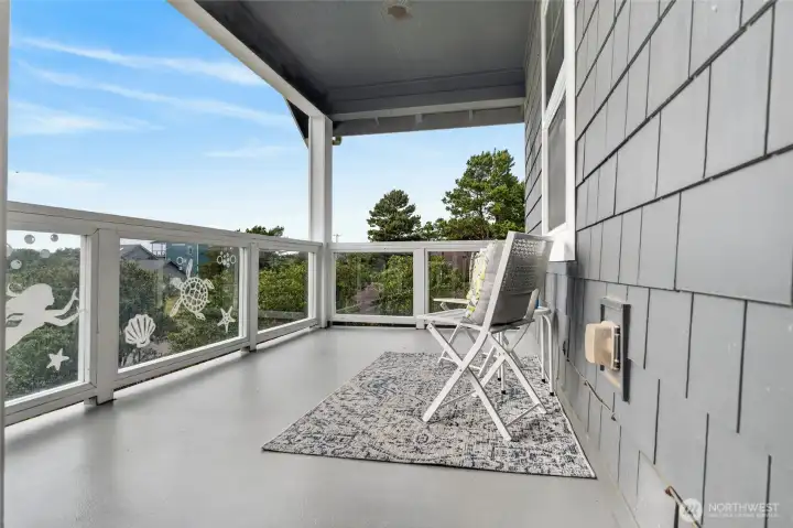 Enjoy fresh ocean breezes, glass panel railings, and tranquil treed neighborhood views.