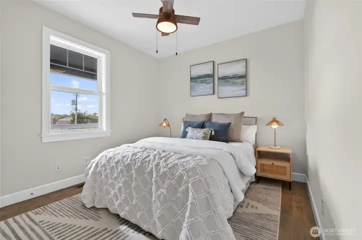 Relax in the spacious bedroom offering a peaceful retreat with plush neutral colors and natural light.