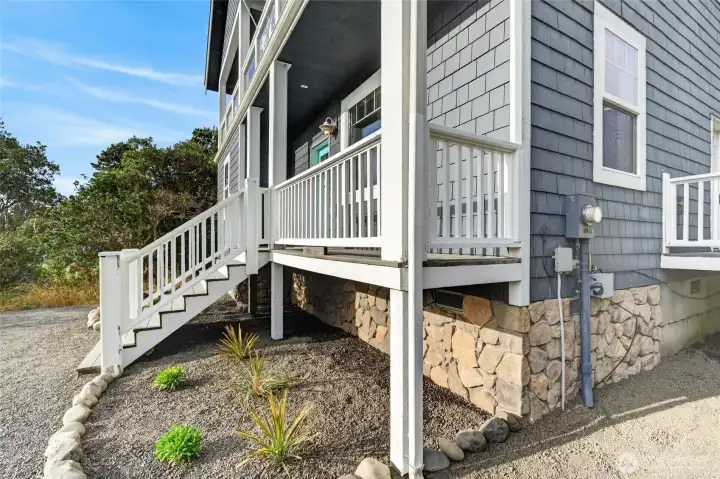 Covered upper-level deck with railings overlooking the trees