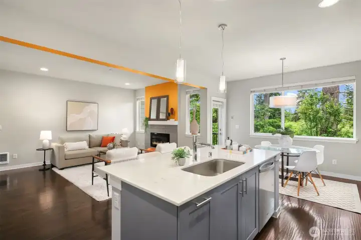 The kitchen and eating bar open to the dining and living rooms