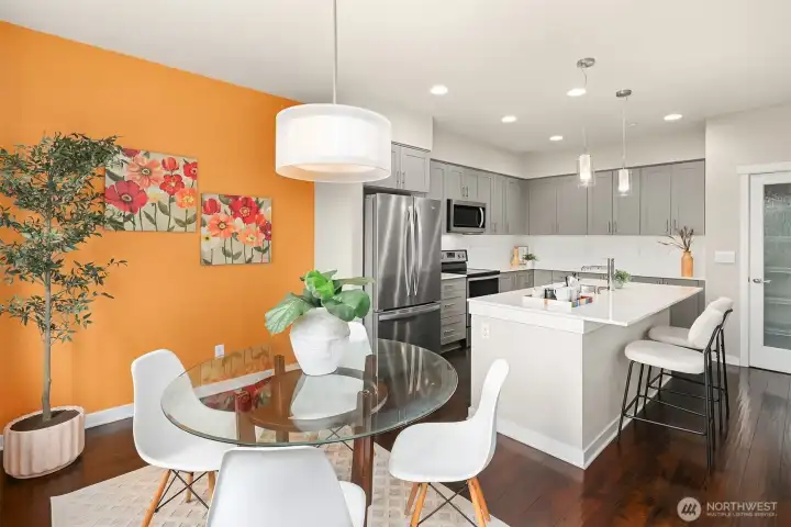 Dining room and kitchen with large eating bar that can easily seat four people