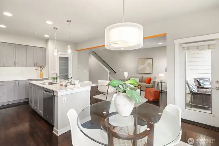 Kitchen and dining room with direct access to the covered deck overlooking the protected greenbelt