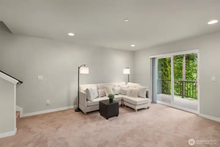 Spacious family room on the lower level with direct access to the lower level, covered deck overlooking the protected greenbelt
