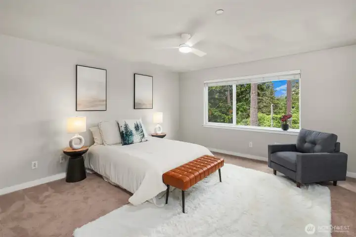 Upper level primary bedroom with treetop views of the protected greenbelt