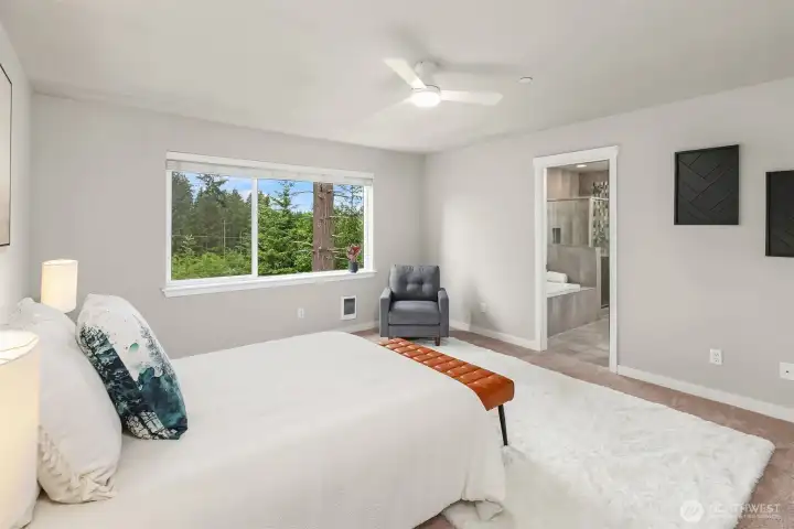 Upper level primary bedroom with treetop views of the protected greenbelt