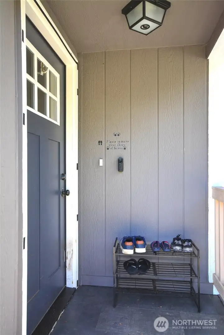 The inviting blue front door adds a charming pop of color and enhances the home's curb appeal.