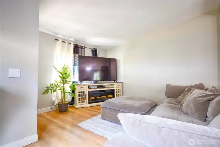 "Bright and inviting living room featuring modern finishes, luxury vinyl plank flooring, and an open layout perfect for relaxing or entertaining."