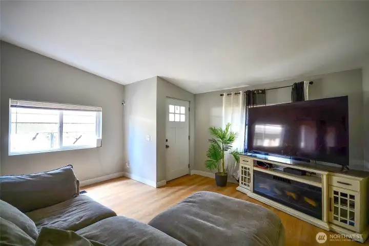Another view of the spacious living room, showcasing the open flow, updated finishes, and versatile space for everyday living and entertaining."