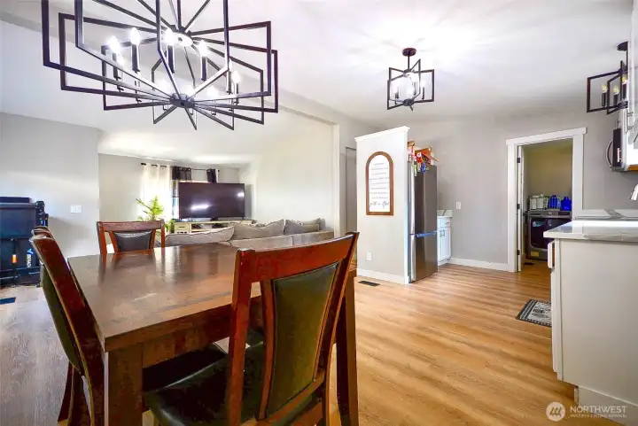 This view captures the seamless connection between the dining area and the home's main living spaces."