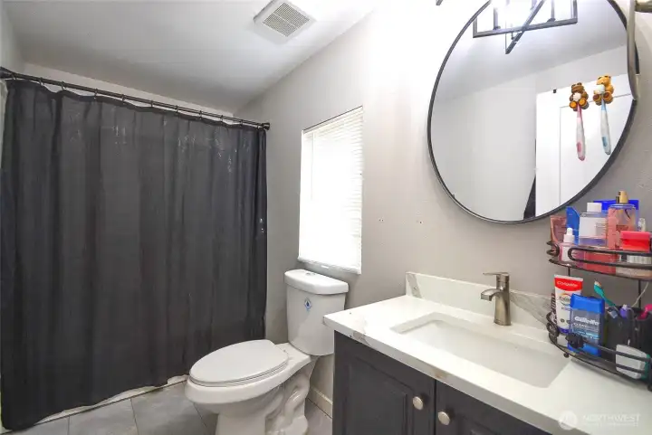 Beautifully renovated primary bathroom designed for comfort and everyday convenience.