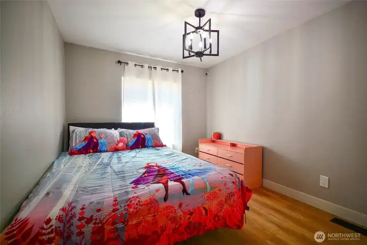 Comfortable kids’ bedroom offering a bright, versatile space for rest, play, and creativity