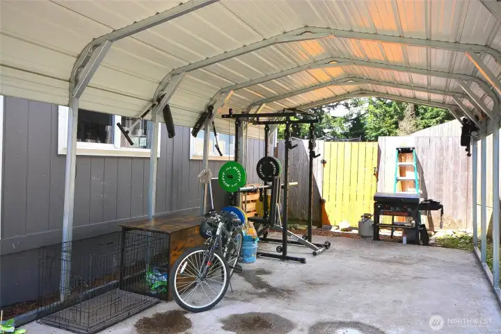 Spacious carport offering shelter for vehicles and added everyday convenience