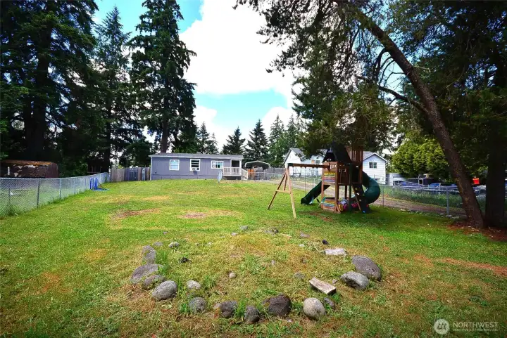 Large, fully fenced front yard providing privacy, security, and room to play or garden