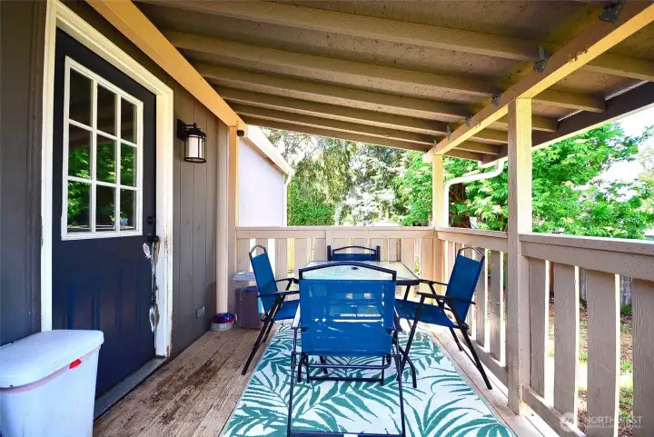 Relaxing back porch offering a peaceful outdoor space to unwind and enjoy the backyard.