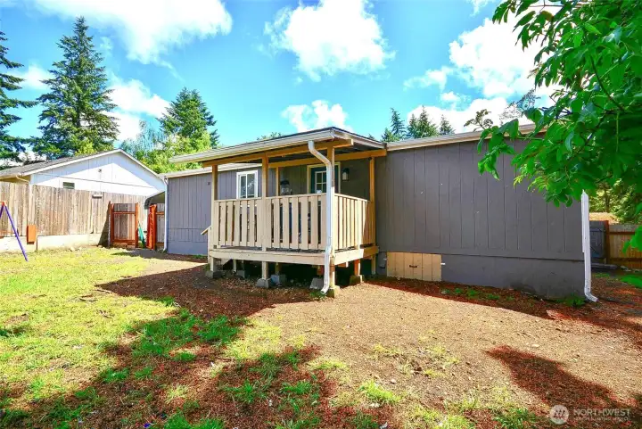 Covered back porch perfect for entertaining, grilling, or quiet evenings outdoors