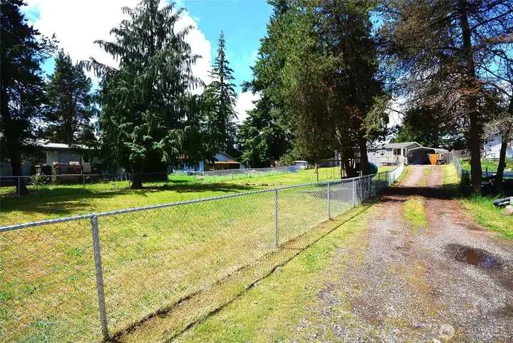 Long, well-maintained driveway offering abundant parking space for residents and guests