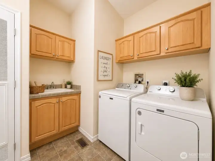 Laundry room, features plenty of storage cabinets and utility sink Laundry room, features plenty of storage cabinets and utility sink