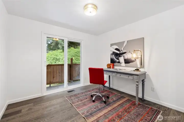 Enjoy access to the rooftop deck from Bedroom 1 staged as an office. Enjoy access to the rooftop deck from Bedroom 1 staged as an office.